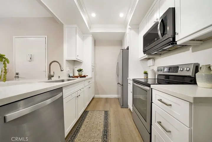 Beautiful and resilient quartz countertops, stainless steel appliances, and soft-close custom cabinets.