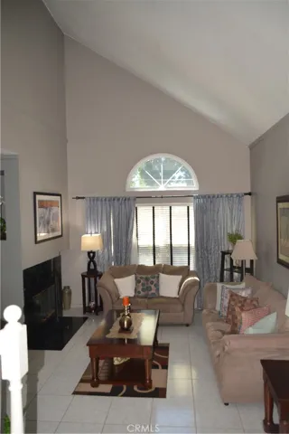 LIVING ROOM WITH HIGH CEILING & FIREPLACE