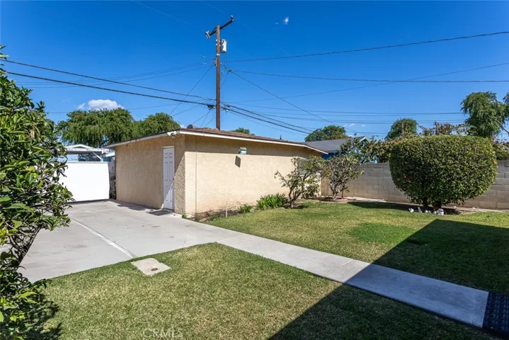 Detached Garage with alley driveway access and wrought iron security gate