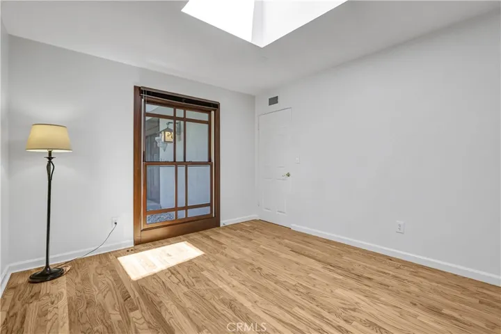 Large second bedroom with skylight and large wall closet