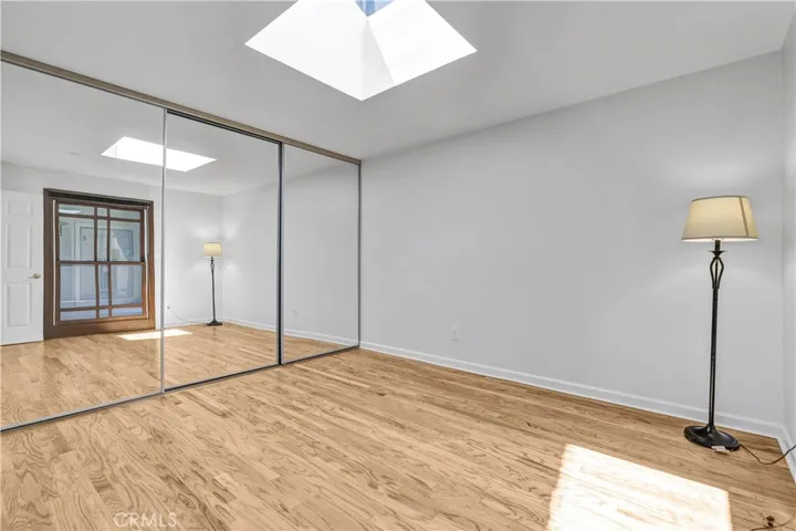 Large second bedroom with skylight and large wall closet
