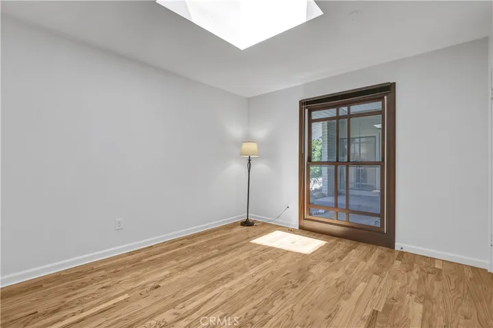 Large second bedroom with skylight and large wall closet