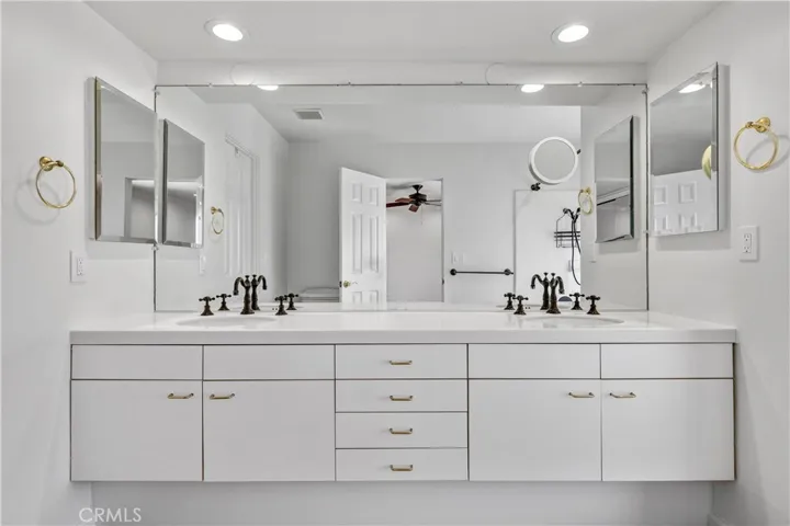 Modern bath with enormous dual sink vanity, slightly sunken tub/shower with abundant natural light from the floor to ceiling window