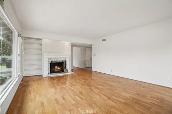 Living room looking to entrance, kitchen and secondary bedrooms