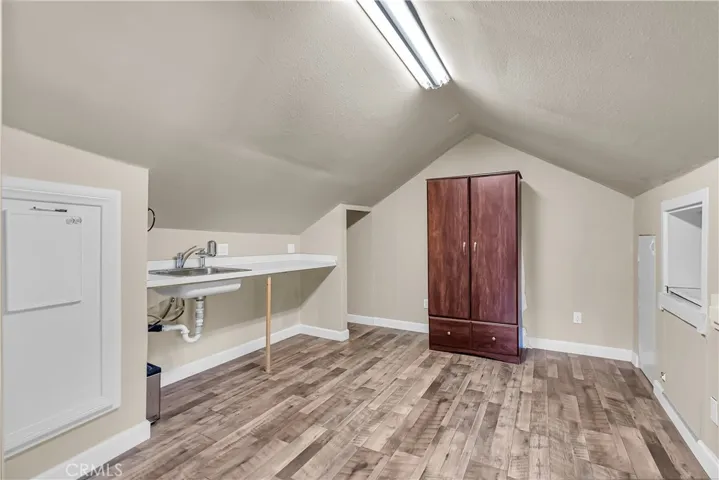 Upstairs bedroom to the left -- with sink, so this whole upstairs could be utilized as a separate rental unit or made into two separate bedrooms.