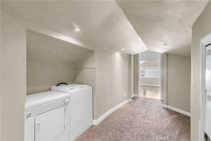 Second floor Laundry units stay with home (note: current owners have never used these units). Doorway into front area with 2 spacious rooms which could be set up as 2 bedrooms or a giant playroom.