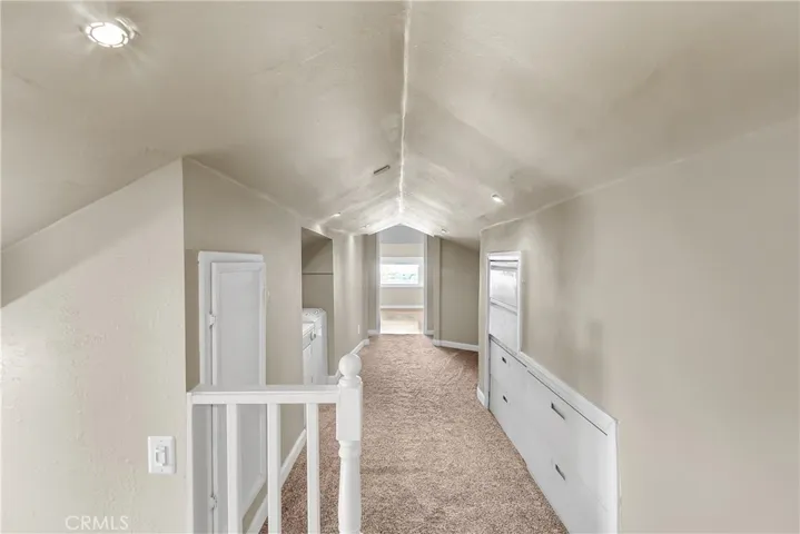 Hallway leading to the bedrooms which overlook the front of the house. Note the bulit-in storage to the right.