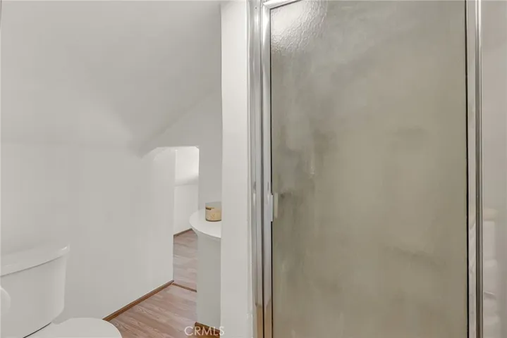 Inside the upstairs bathroom with a low bridge to a small room which could be a playroom or more storage.