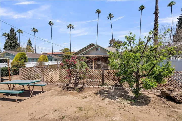 View of backyard from fence line looking toward the house.