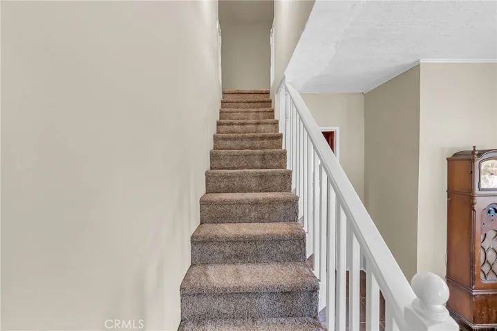 Stairway leads to two more bedrooms, a bathroom, and lots of storage!