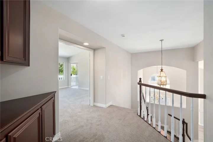 Hallway on second level includes linen cabinets