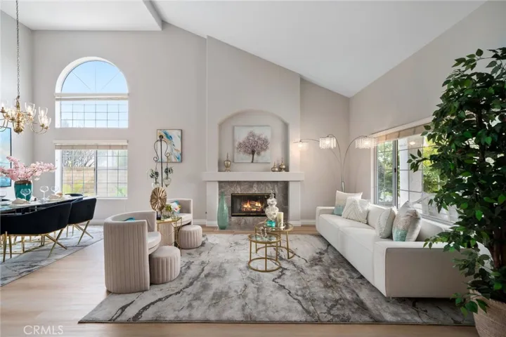 The formal entry welcomes you into the grand living room with soaring ceilings and a cozy fireplace (one of three in the home).