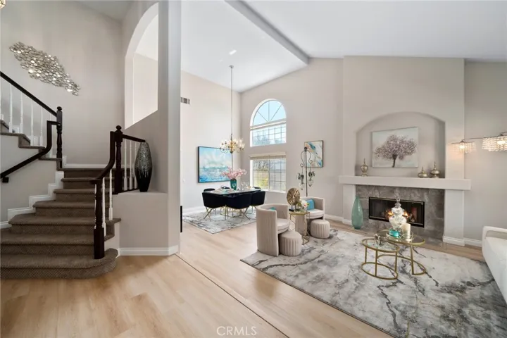 The formal entry welcomes you into the grand living room with soaring ceilings and a cozy fireplace (one of three in the home).  The formal dining room provides ample space for entertaining.  The custom finished staircase adds architectural elegance.  Brand new luxury vinyl-wood wide-plank flooring throughout the main level and fresh new two-tone paint throughout.