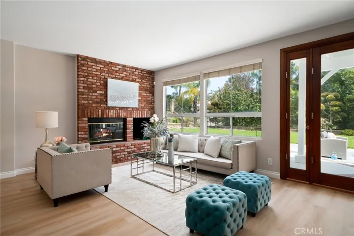 The large family room, complete with a second fireplace and views to the backyard