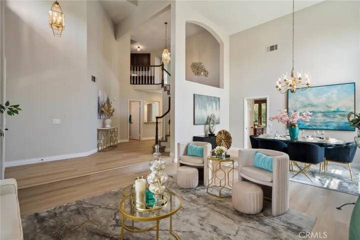 Formal living and dining room featuring soaring ceilings.  Brand new luxury vinyl-wood wide-plank flooring throughout the main level and fresh new two-tone paint throughout.