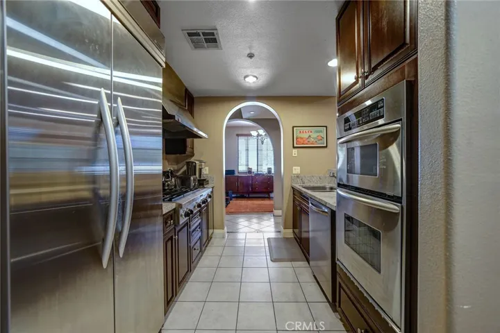 Kitchen has stainless steel appliances, lots of counter tops space and a breakfast bar