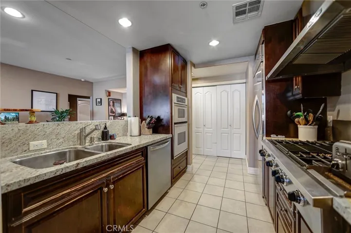 Kitchen with lots of counter tops & stainless steel appliances