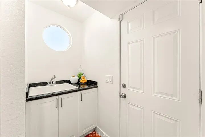 upstairs sink in the hallway, to the right door leading to deck