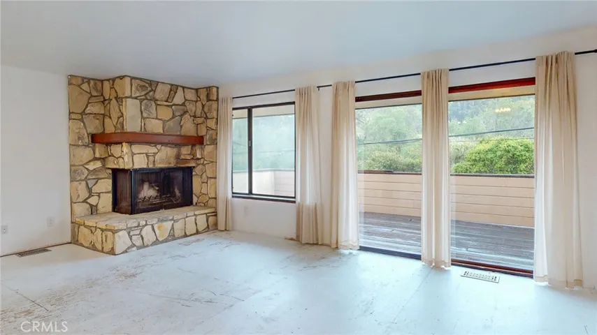 The upstairs apartment also has a deck that looks to the wooded forest across Hwy 1.