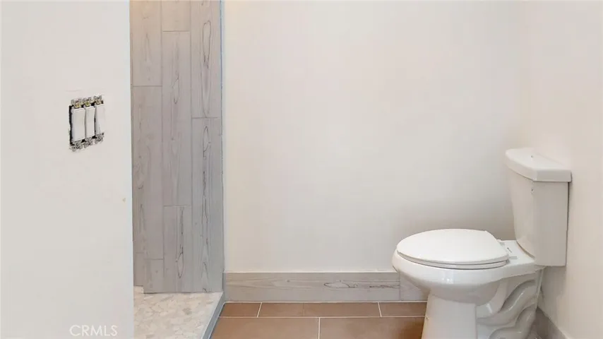 A vanity, sink, mirror and shower fixtures are needed to complete the updated bathroom.