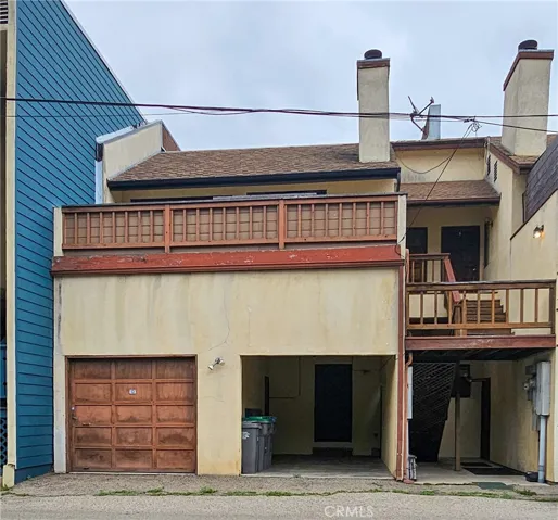 Single car garage and carport at the back of the building, with shared staircase.