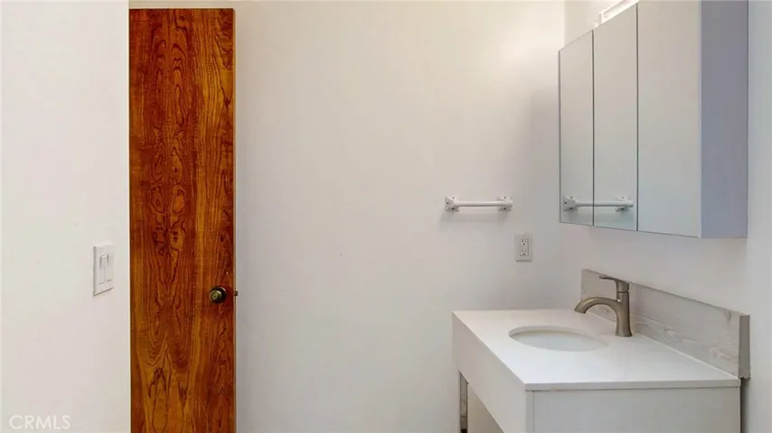 The guest bath has been updated with new tile flooring, new sink and vanity, new toilet.