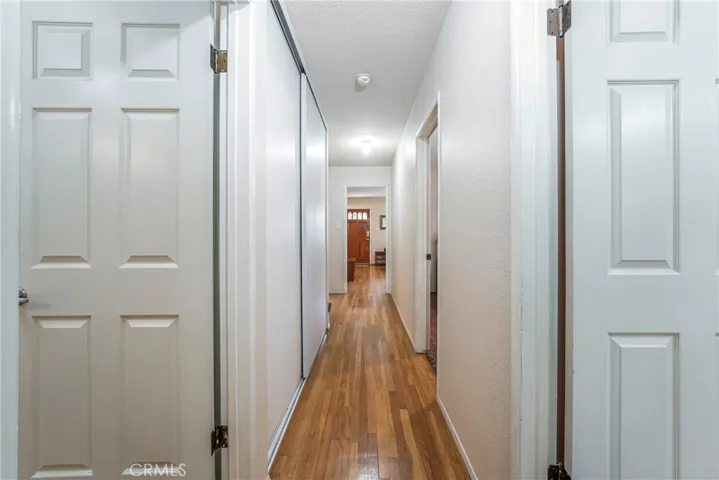 Hallway to full bathroom and 3 bedrooms