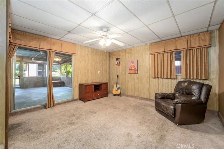 Den (garage conversion) with ceiling fan, a/c unit and sliding glass door to patio