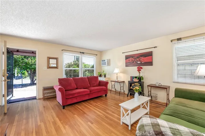 View of living room with front door open to courtyard