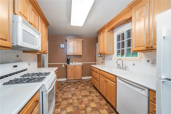 Galley kitchen with upgraded cabinets and countertops