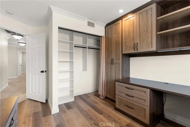 Office with built in shelving and closet for added storage