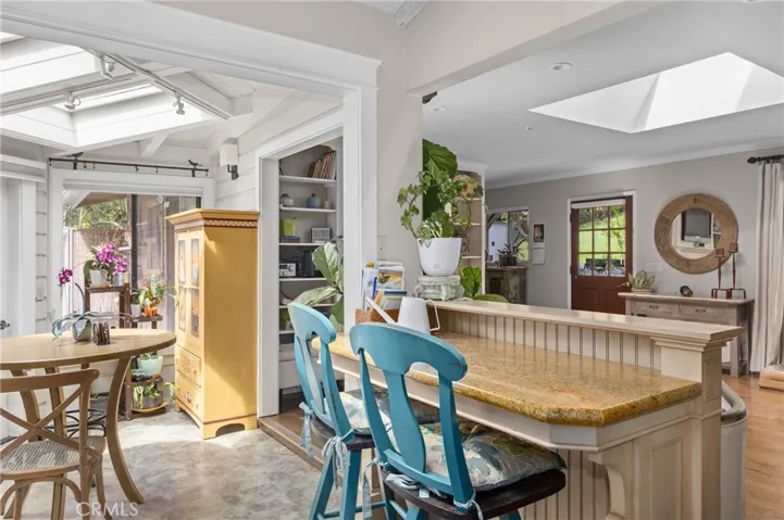 View of breakfast bar, dining area and living room.