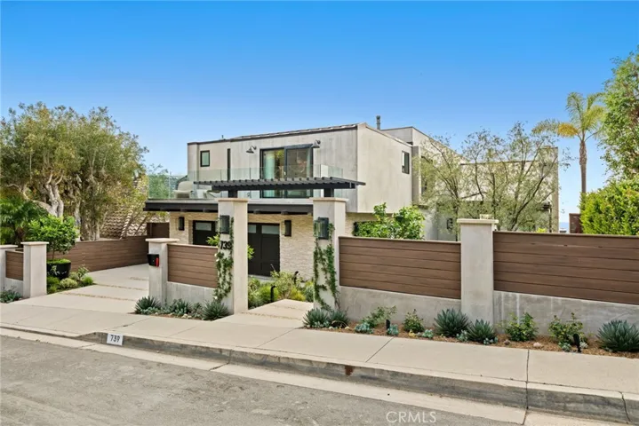 Parking for four is accommodated with two driveway spaces and a two-car garage.