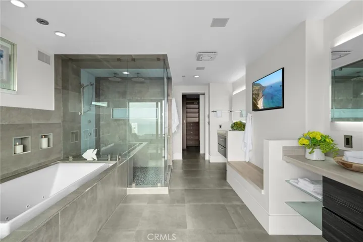 An oversized rain shower and a soaking tub enrich the primary bath. On par with the interior, the exterior of the home is exceptional.