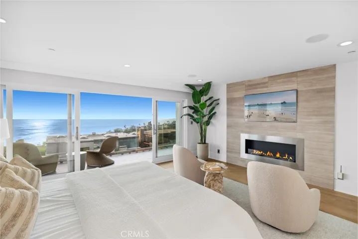  For the ultimate escape, the fireplace-warmed primary suite opens to sweeping ocean views on a private deck and reveals a sitting room and two walk-in closets.