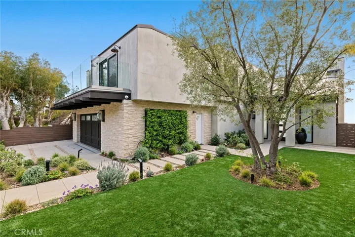Curb appeal is redefined with impeccable landscaping and custom front-yard hardscaping.