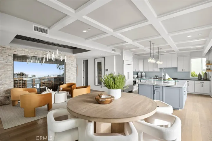 A lounge and glass-enclosed temperature-controlled wine room set the tone for elegant dinner parties in the dining room, which transitions seamlessly to a fabulous island kitchen.