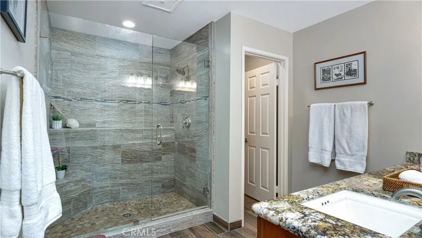 A stunning Primary Bath with an oversized walk- in shower and tile floor