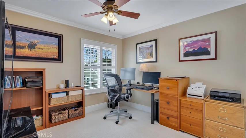 The upstairs office- crown moldings and ceiling fan