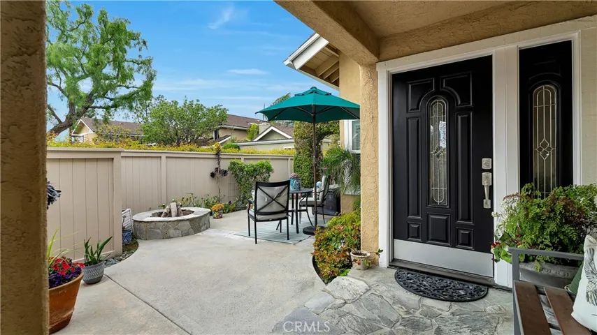 Elegant entry and side patio with firepit and fountain