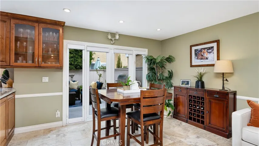 a glass door display cabinet. French doors open onto the patio