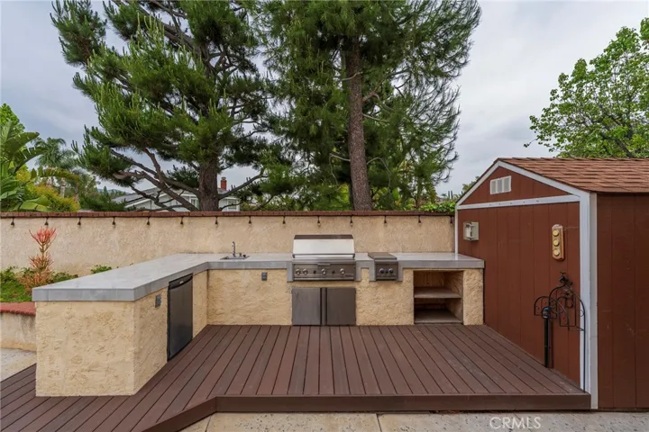 Outdoor BBQ, cooktop, sink, refrigerator and storage shed