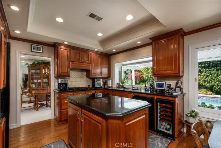Updated kitchen with newer appliances, recessed lighting, a wine refrigerator, and custom cabinets