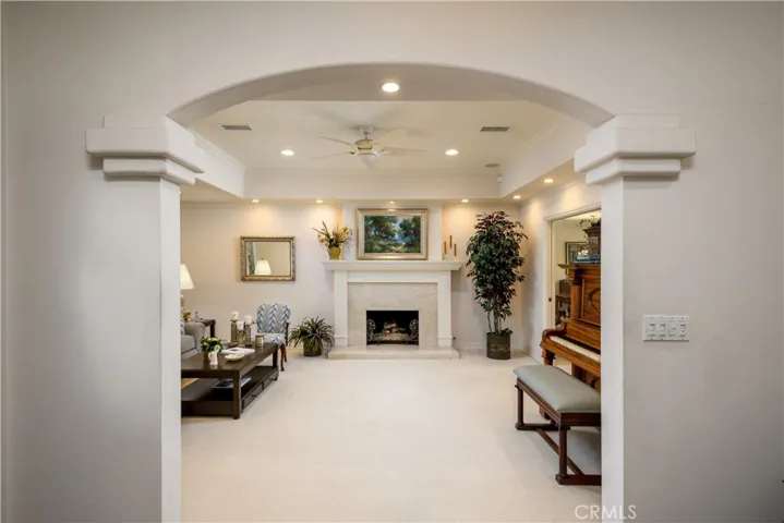 Formal living room with a marble hearth, recessed lighting and lots of natural light