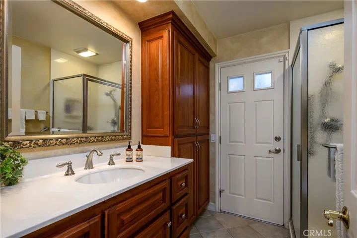 Downstairs bath with a door to the backyard to service the pool