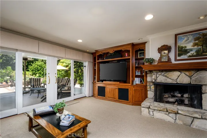 Generous den with a second fireplace and built-in entertainment center