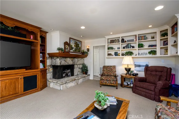 The den leads to a laundry room, downstairs bedroom, 3/4 bath, and direct garage access