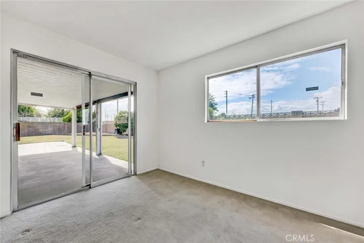 Downstairs Bedroom With Sliding Glass Door to Patio