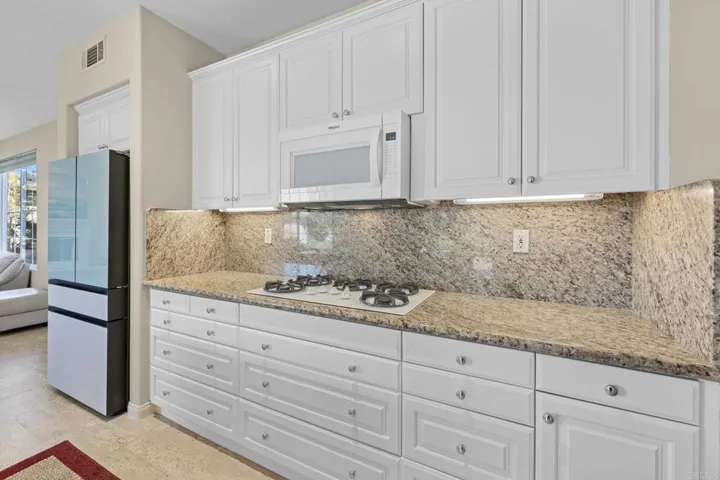 Kitchen with 5 Burner Gas Cooktop and Newer Refrigerator with Lots of Bells & Whistles