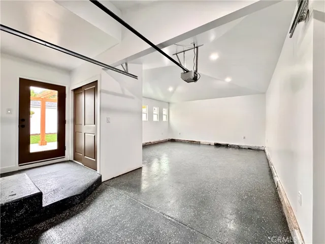 Huge Attached double car garage finished out with drywall & recess lighting.